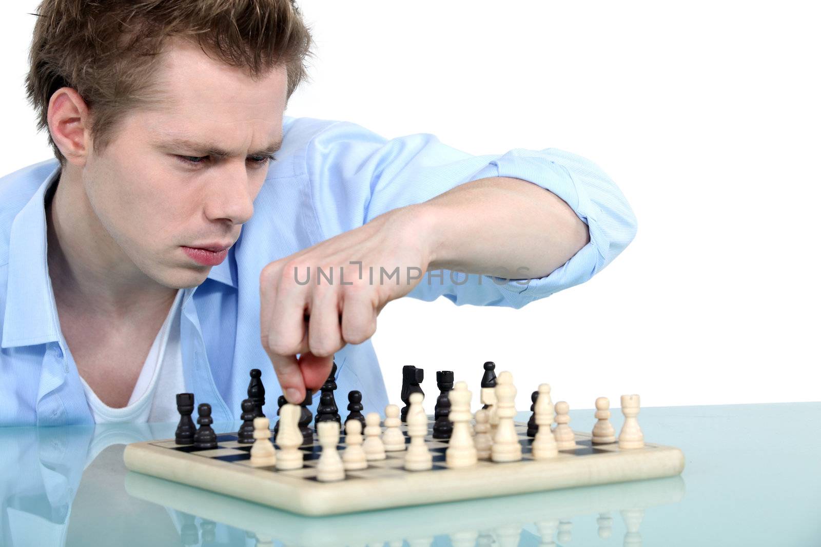 Man playing chess alone by phovoir