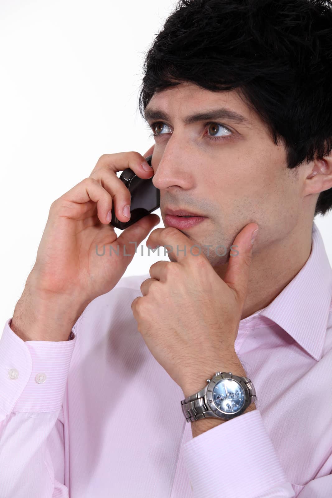 Thoughtful businessman on the phone