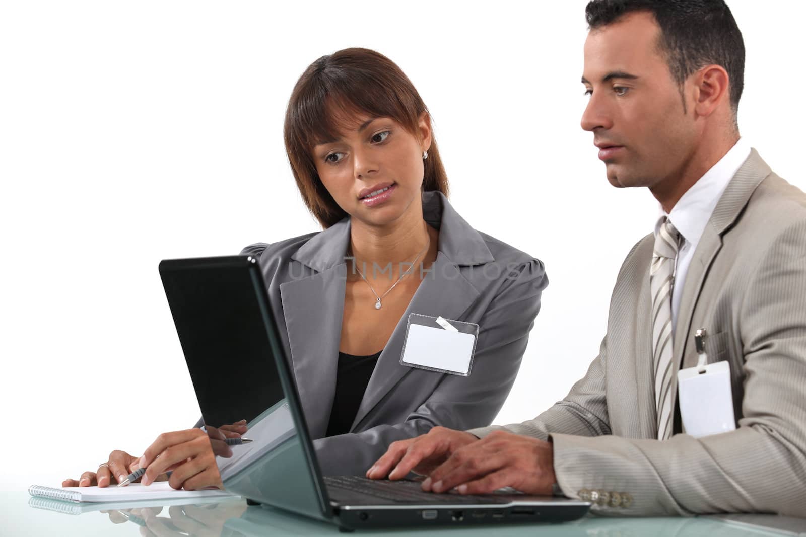 Two business visitors working with laptop by phovoir