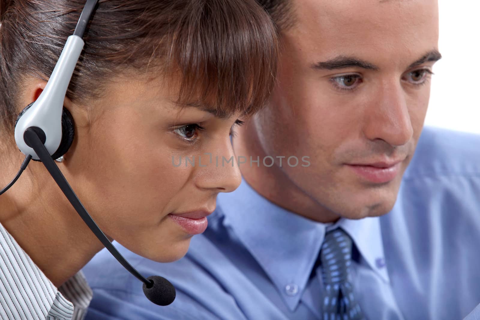 Close up of a business couple with a headset by phovoir