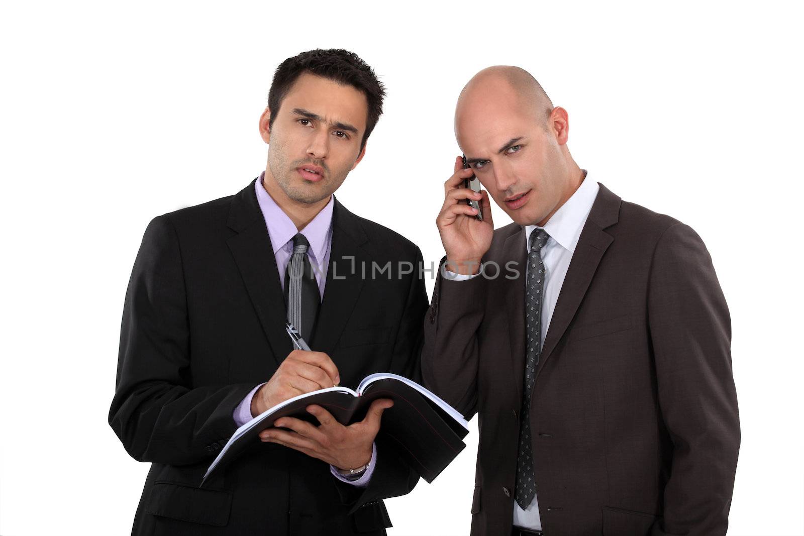 Serious businessmen with a cellphone