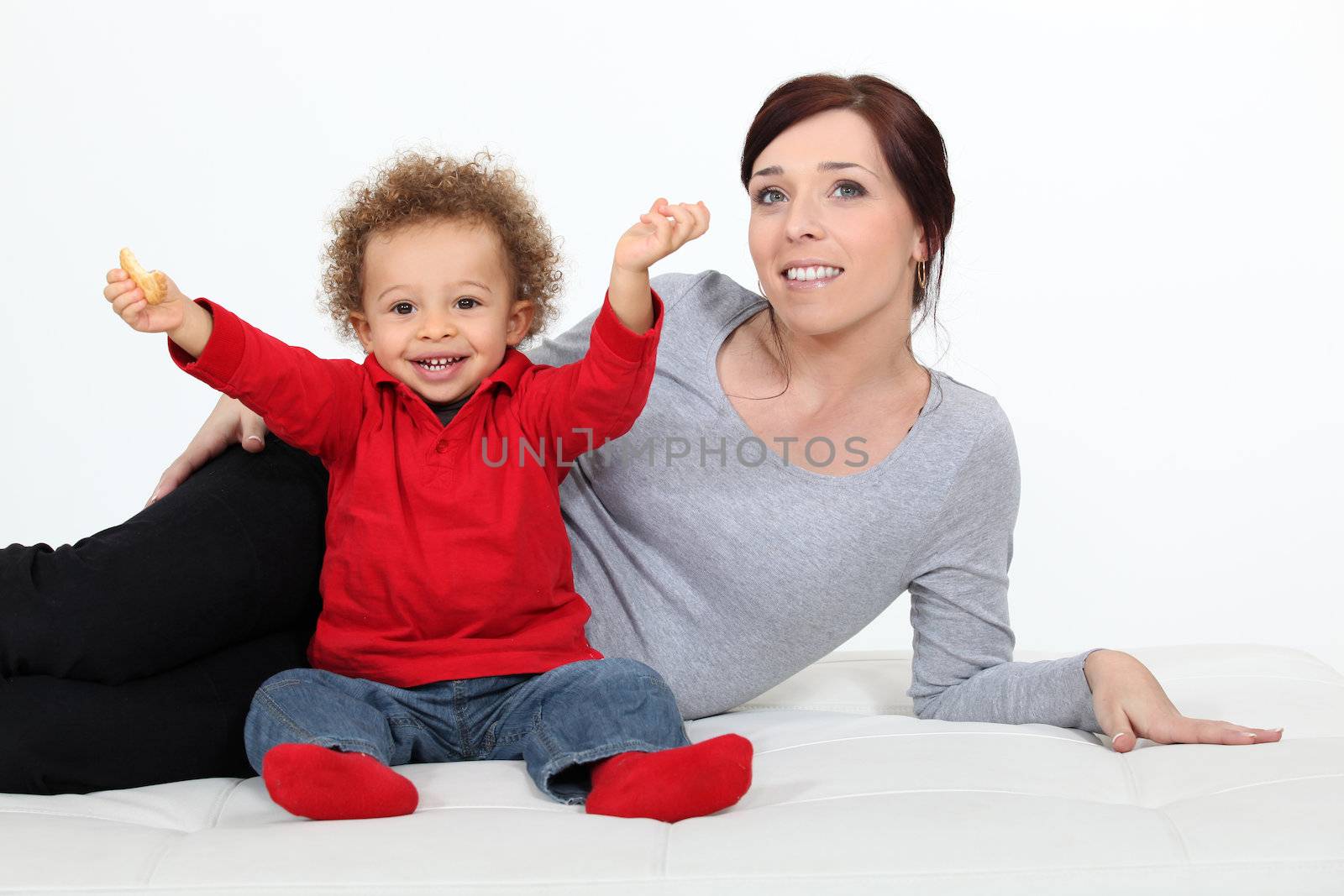 Toddler sat on the floor with mother by phovoir