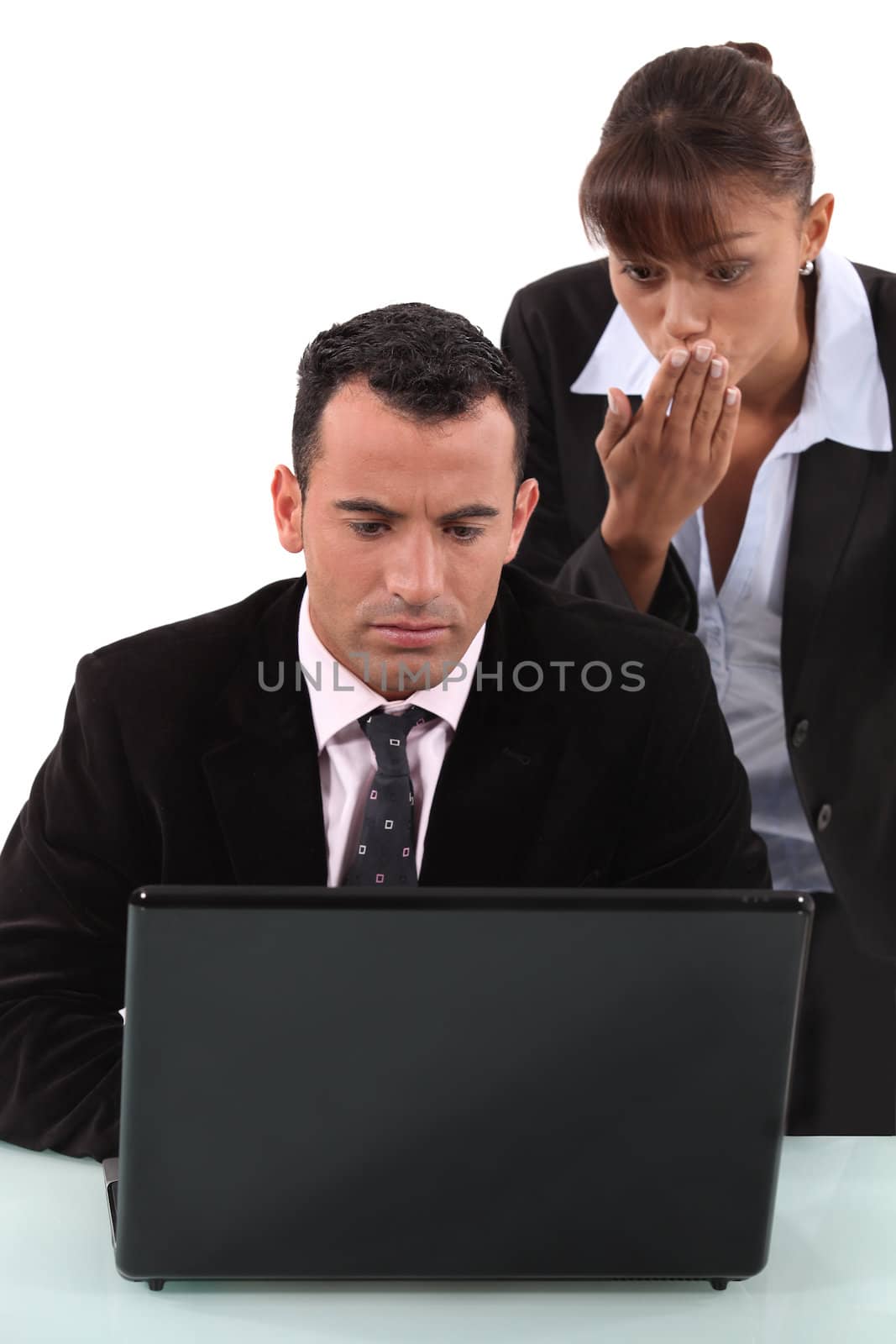 Man and woman surprised in front of laptop by phovoir