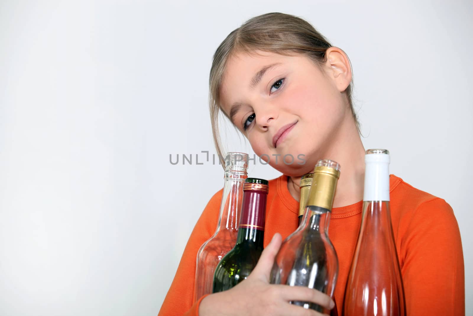 Girl with empty glass bottles