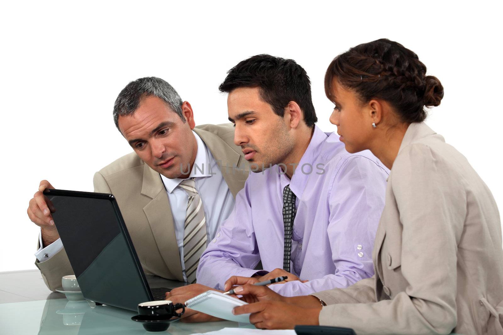 Business people looking at a laptop