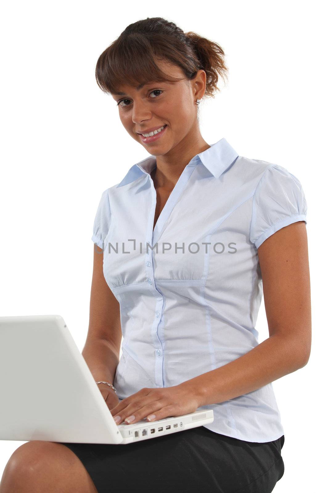 young businesswoman working on her laptop by phovoir