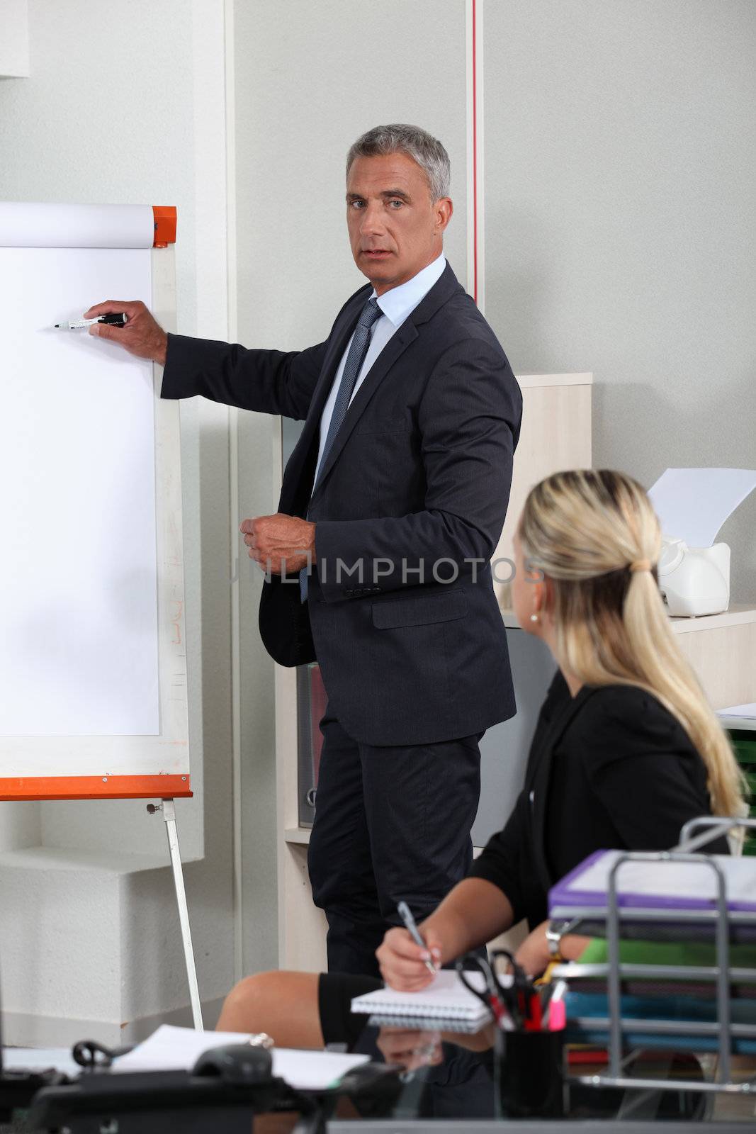 Businessman giving a presentation by phovoir