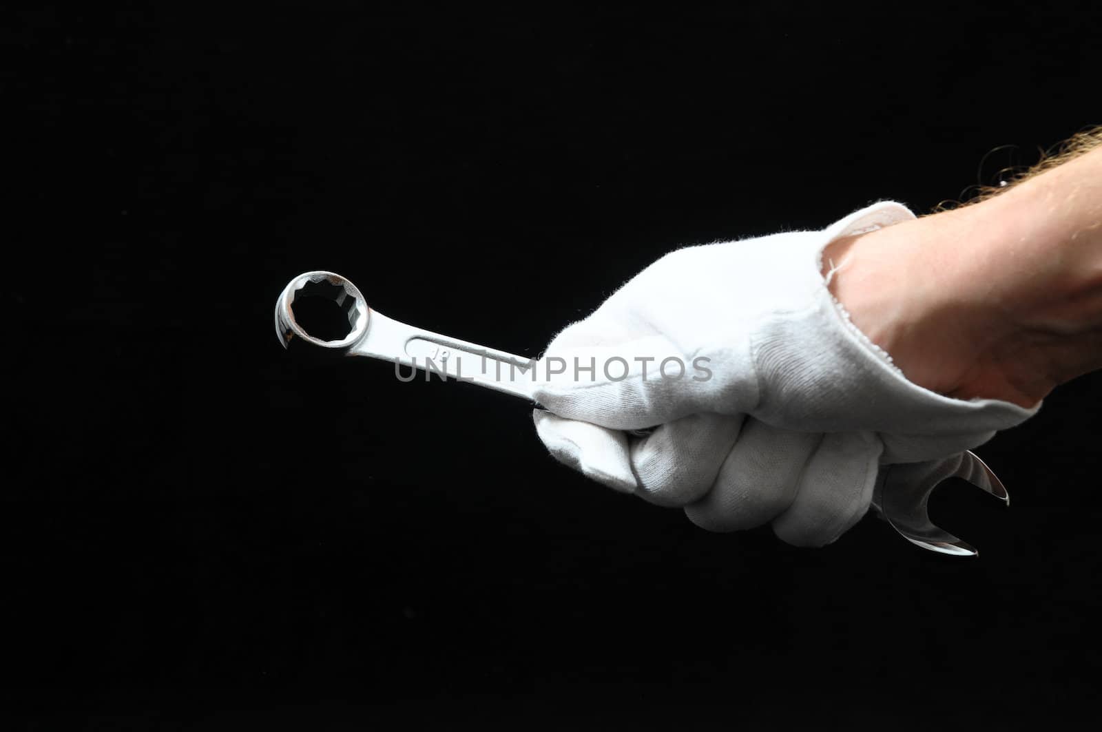 One Key Bolts and a Hand on a Black Background