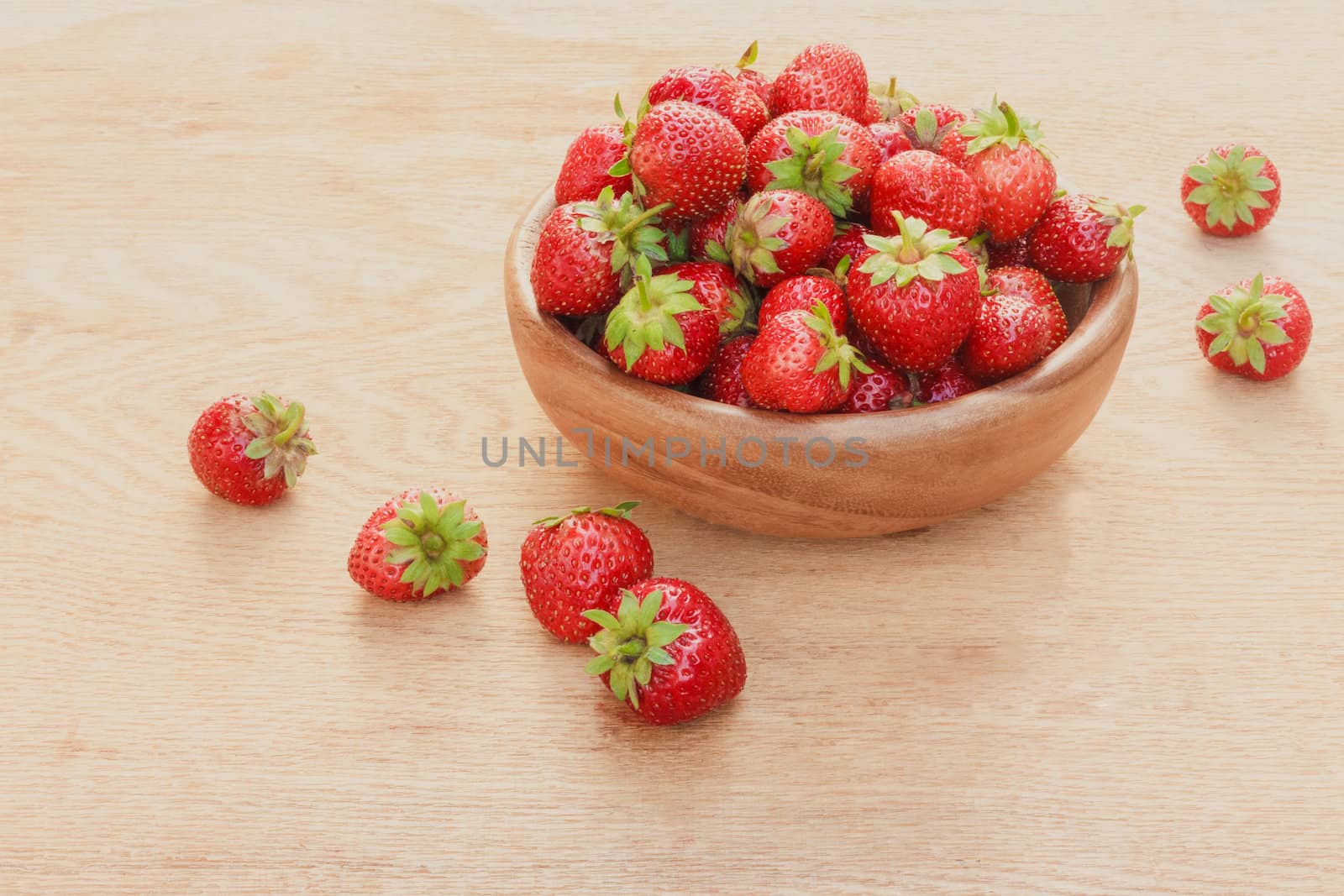 Close-Up Of Strawberries In Vintage Wooden Bowl On Table by ryhor