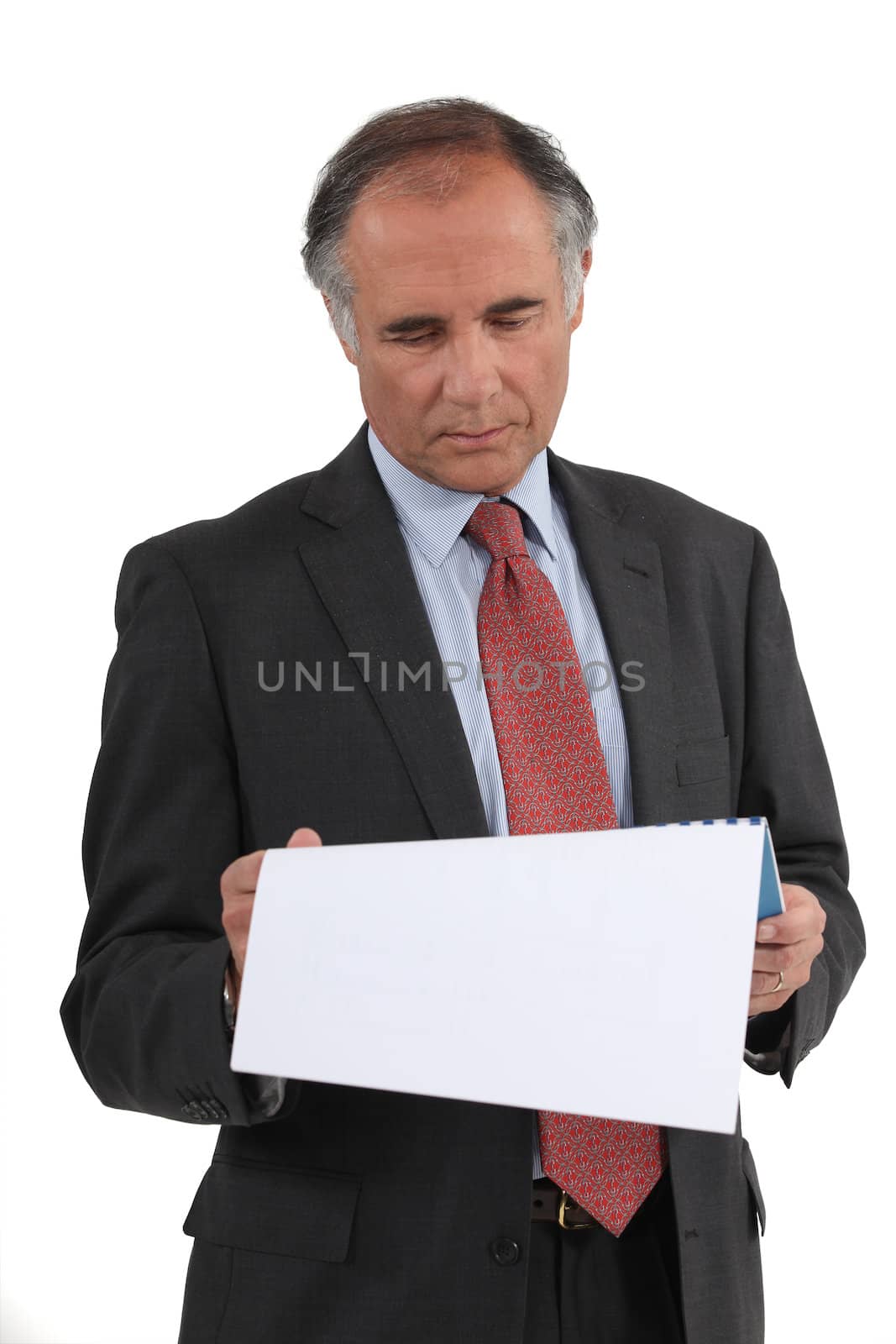 Businessman reading a document by phovoir