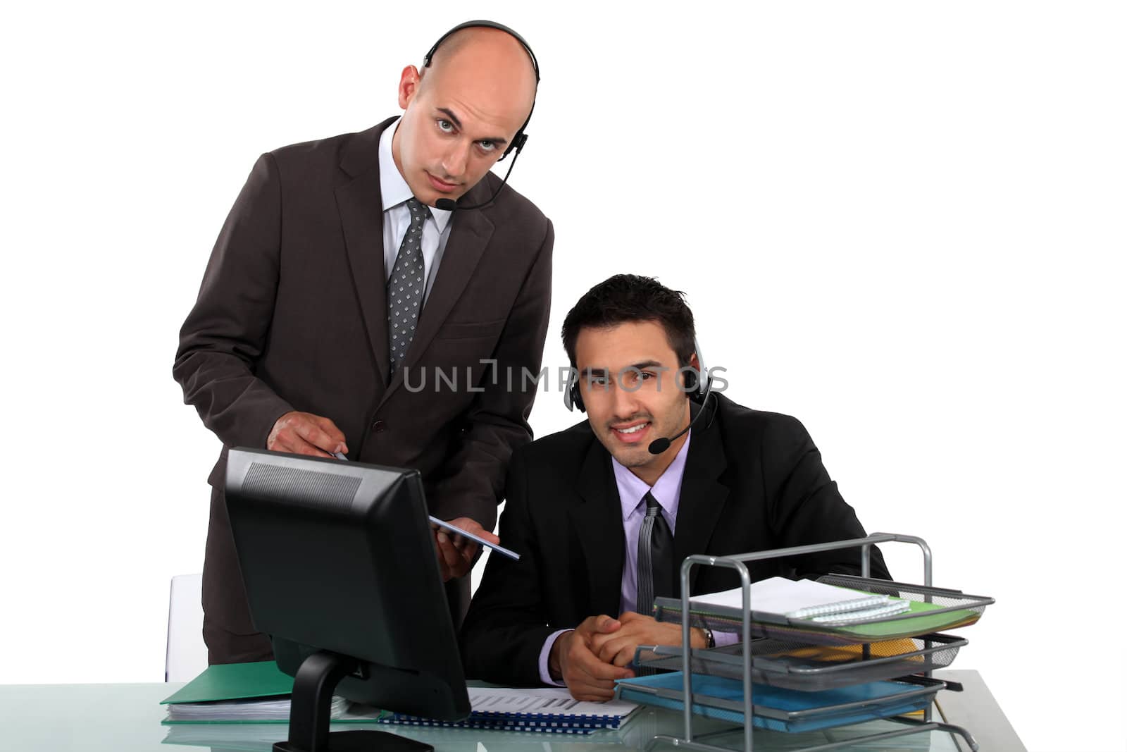 Businessmen wearing headsets by phovoir