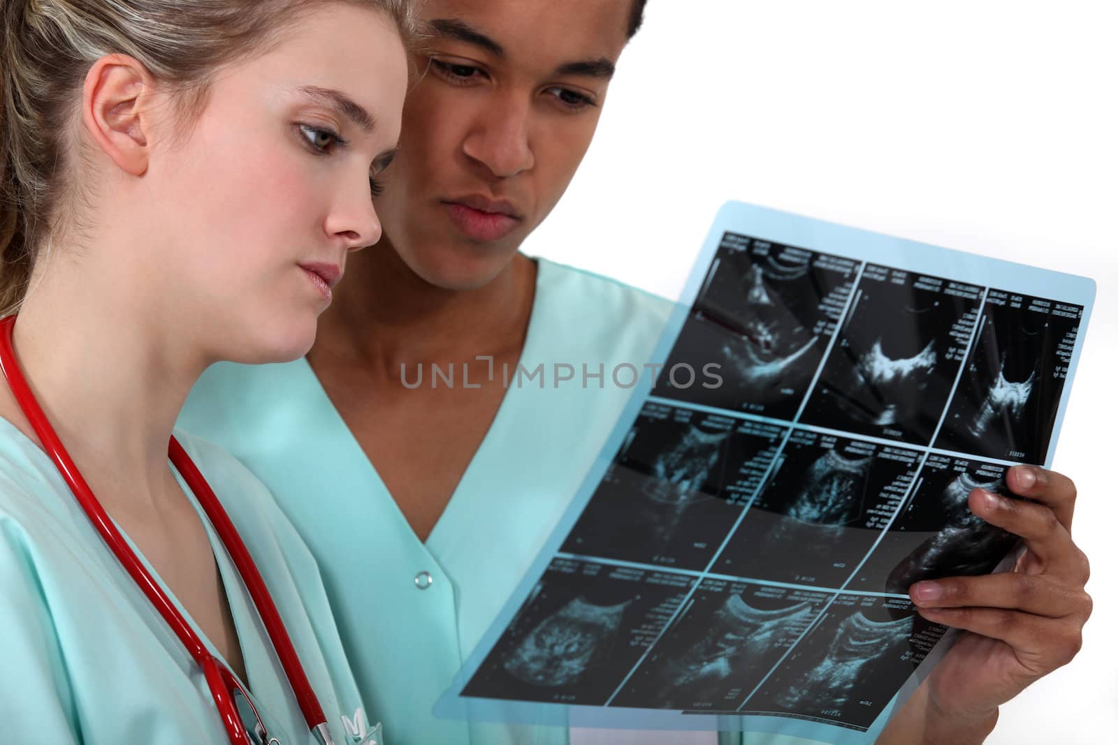 Two doctors examining a radiography. by phovoir