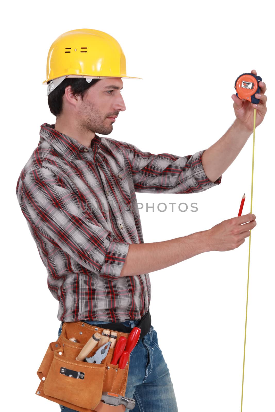 Man measuring using tape measure by phovoir