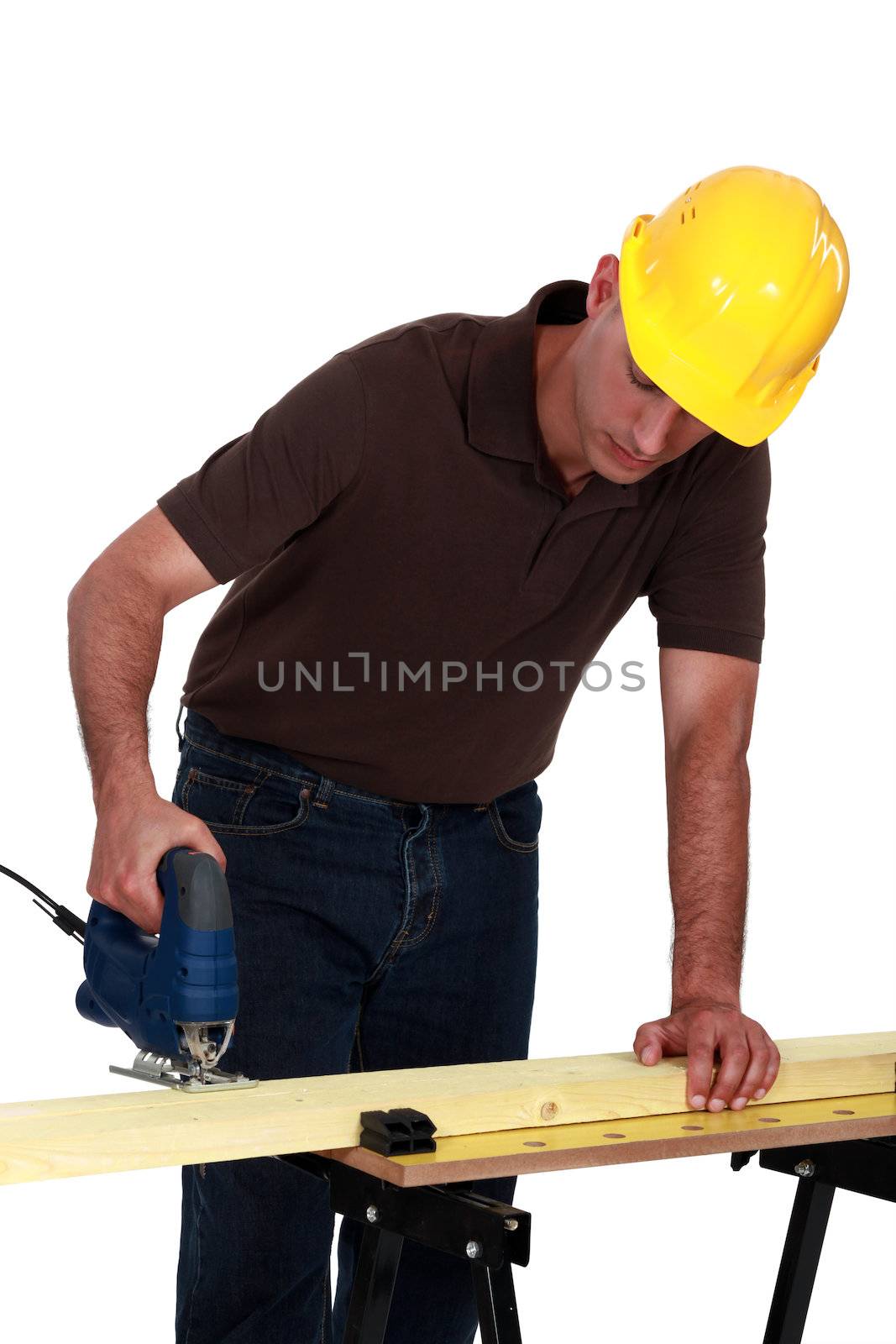 Tradesman using a jigsaw by phovoir