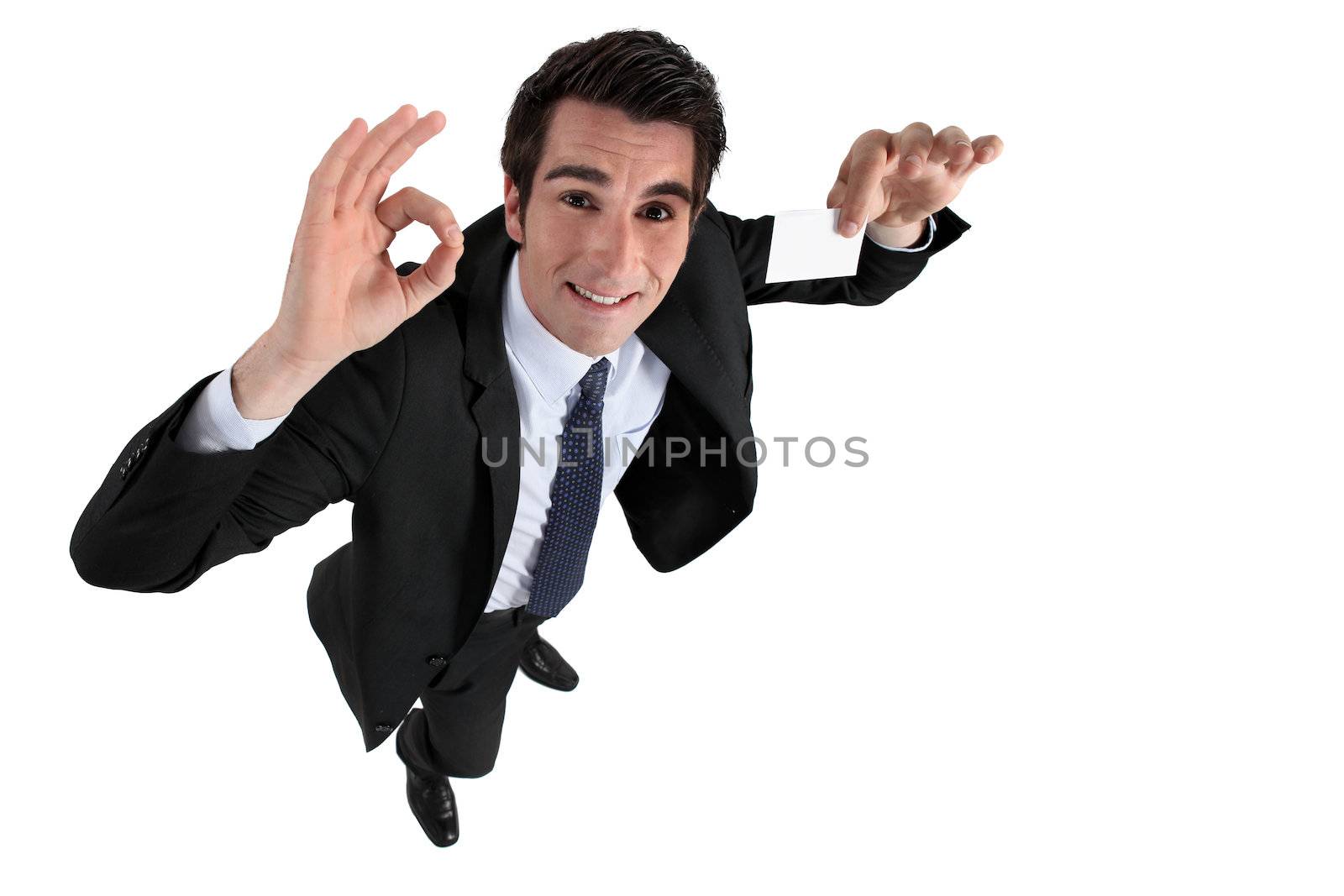Businessman holding blank calling card by phovoir