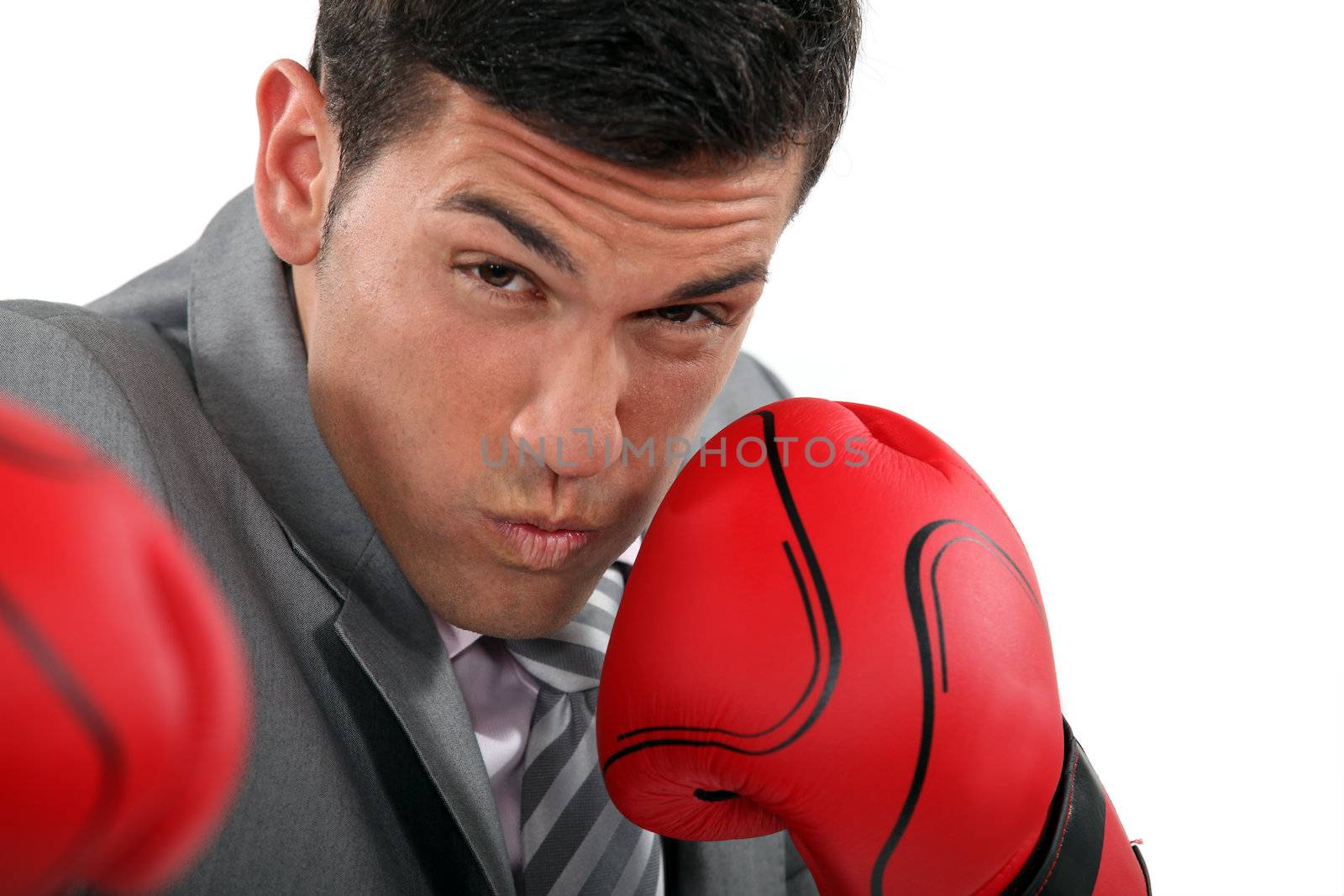 Businessman throwing punches by phovoir