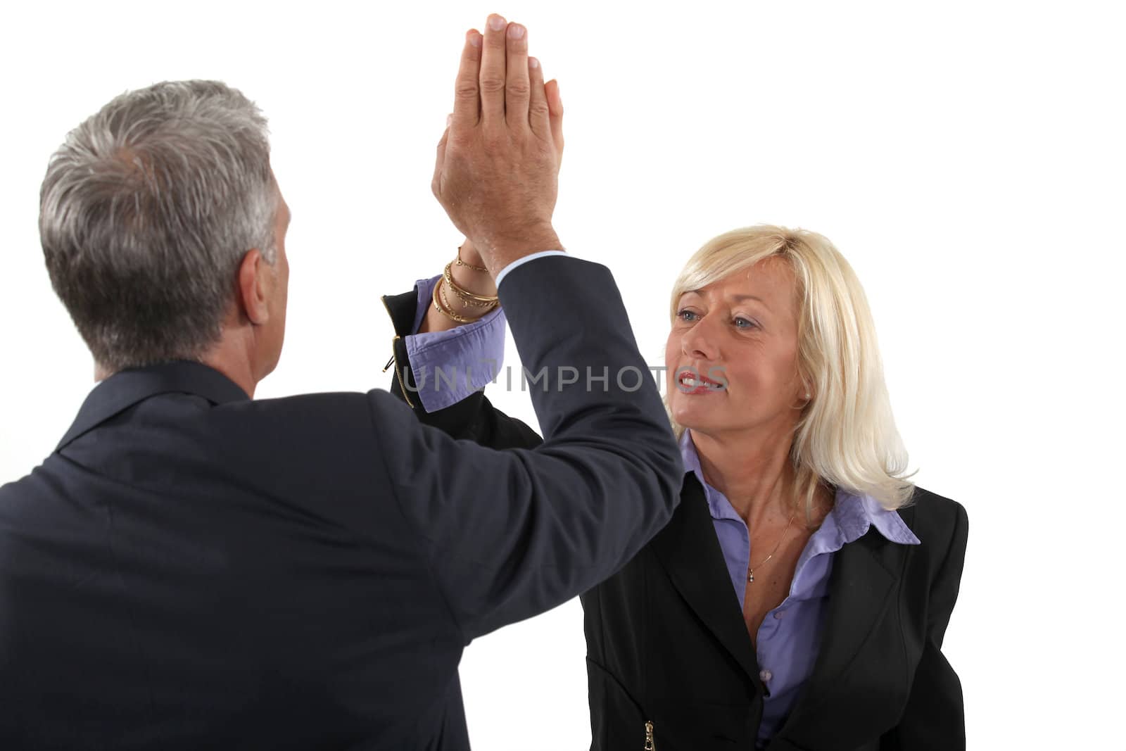 Business couple with their hands together by phovoir