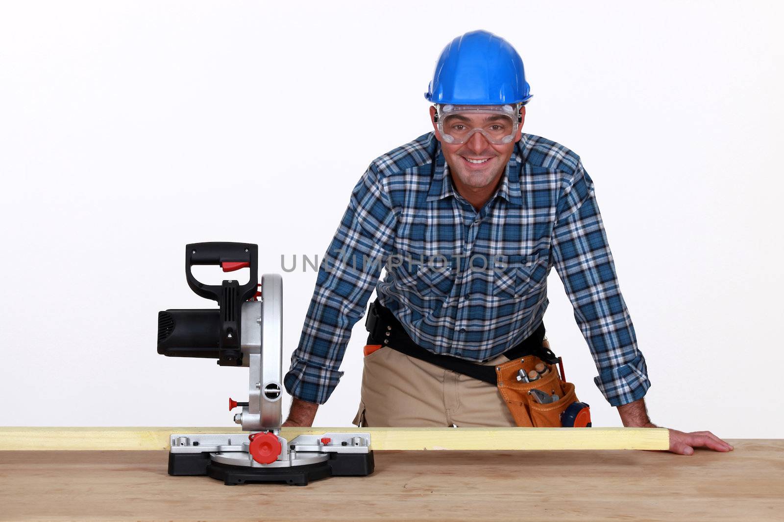 Man with circular saw by phovoir