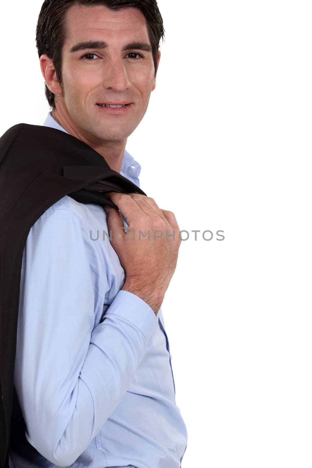 Successful businessman posing with jacket over shoulder by phovoir