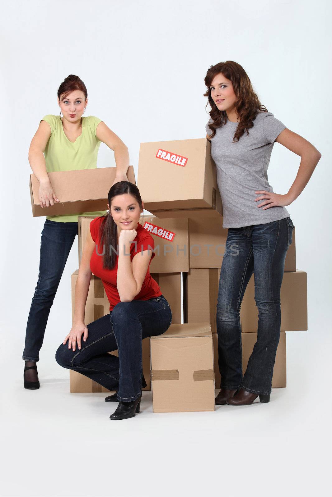 Three woman stood by pile of boxes by phovoir