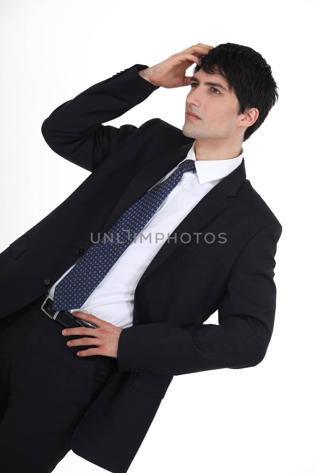 Young businessman scratching head