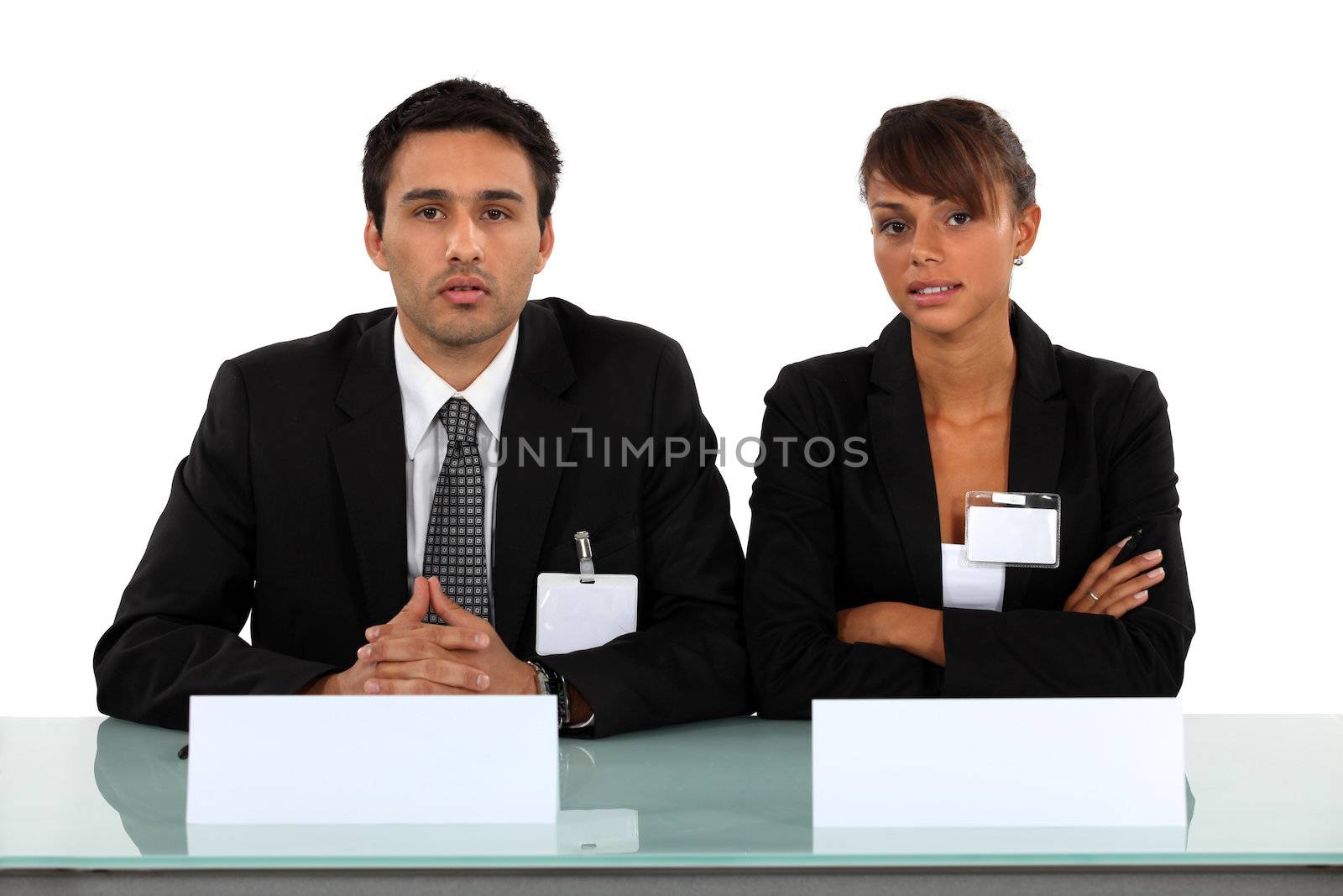 Two businesspeople wearing visitor badges