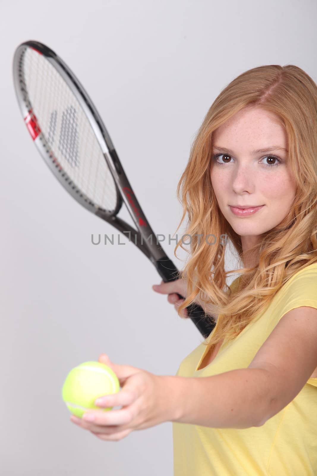 Girl playing tennis by phovoir