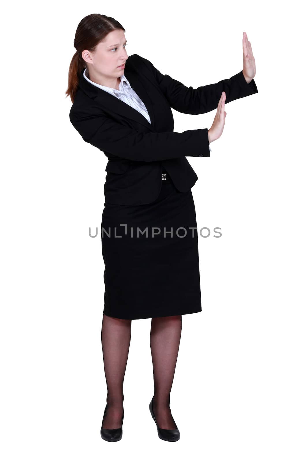 woman in a suit trying to protect herself with her hands by phovoir