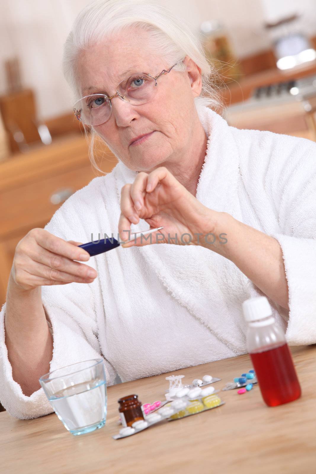 Old lady taking medication by phovoir