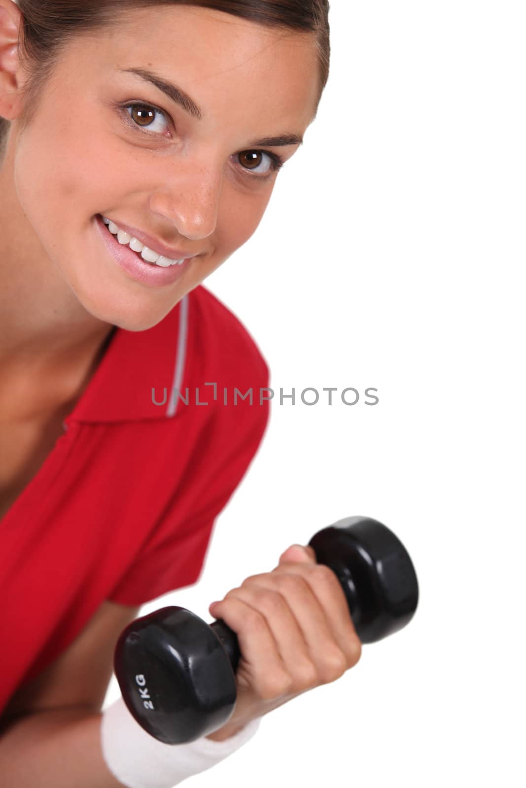 Brunette in gym with dumbbell by phovoir