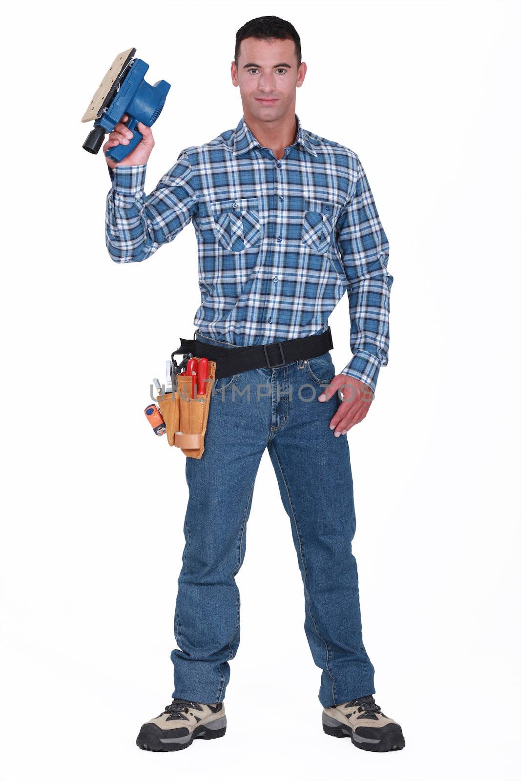 Man with an electric sander by phovoir