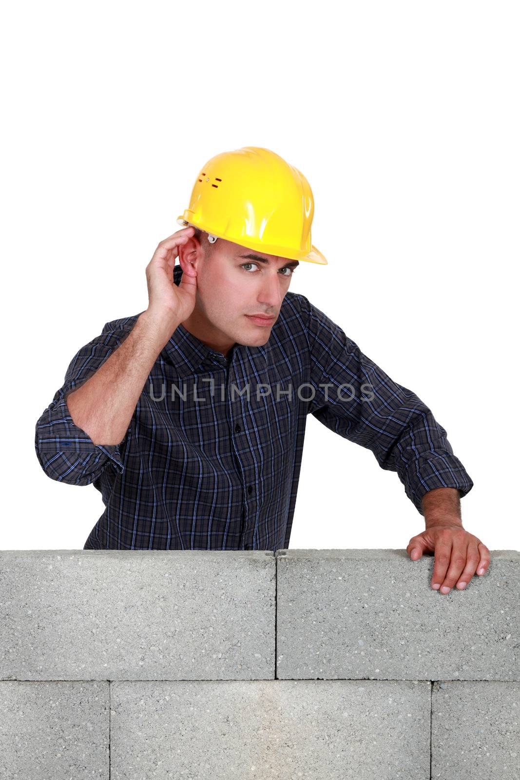 Builder covering ear with hand by phovoir