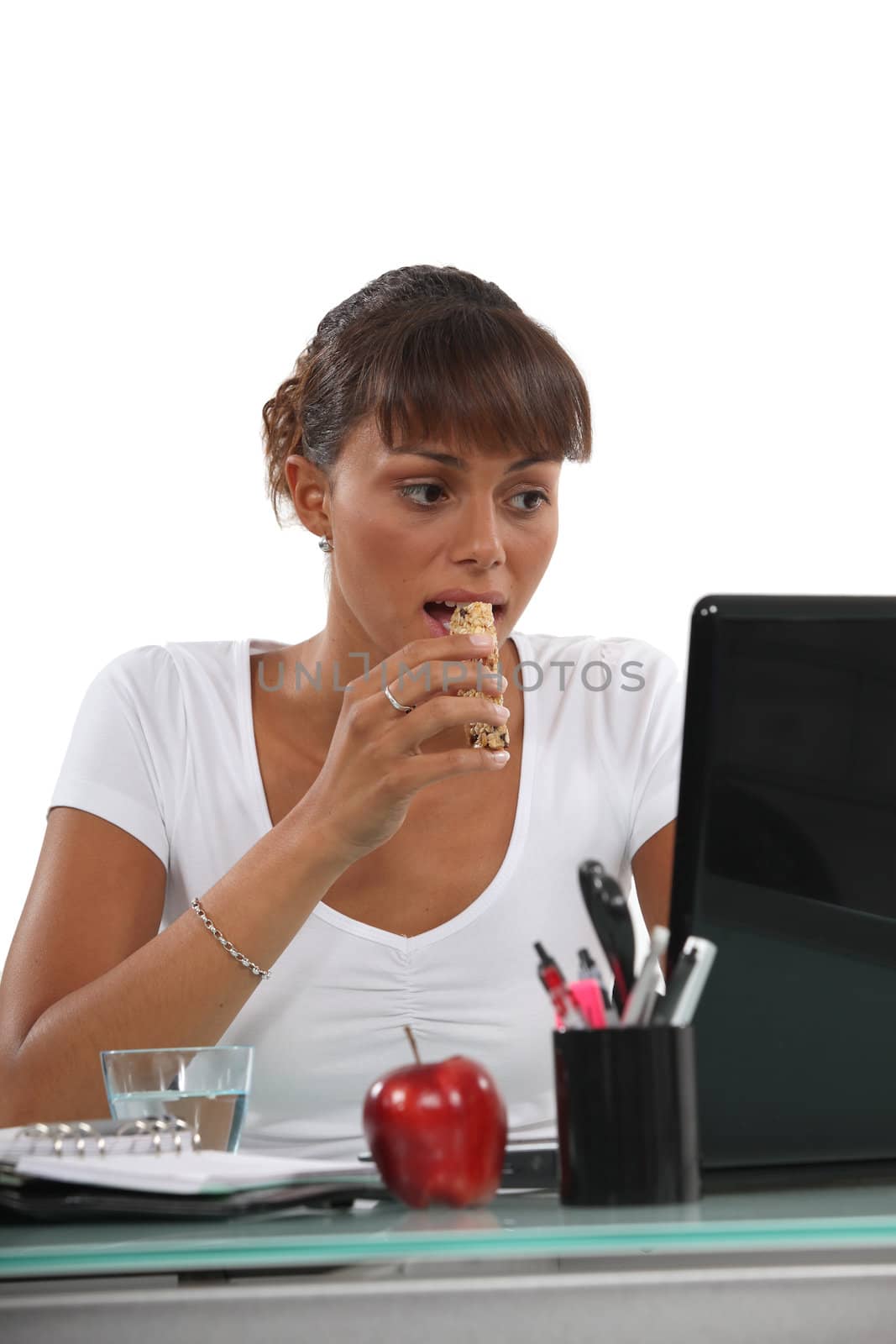 young woman eating a cereal bar by phovoir