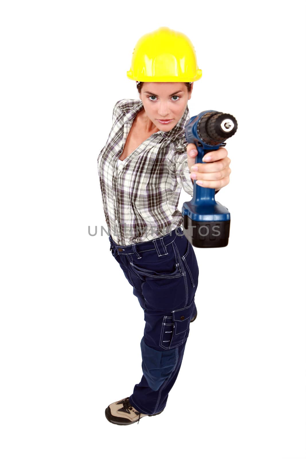 A female construction worker using a drill as a gun.