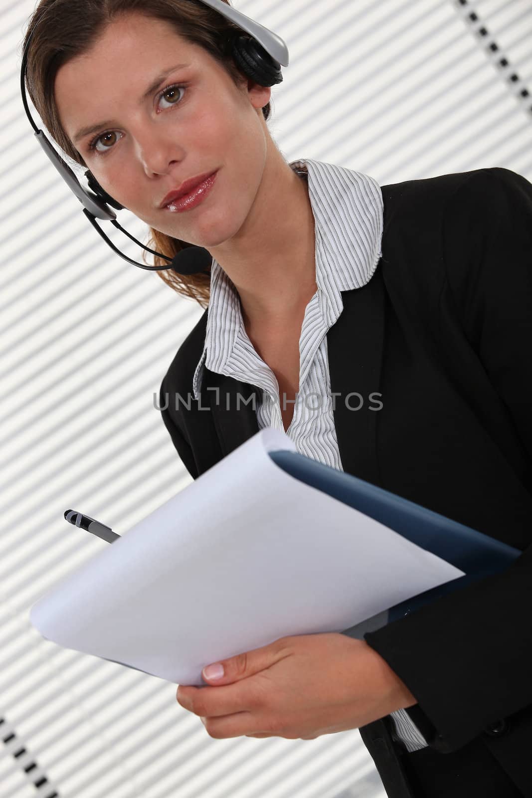 Office worker with a headset and clipboard by phovoir