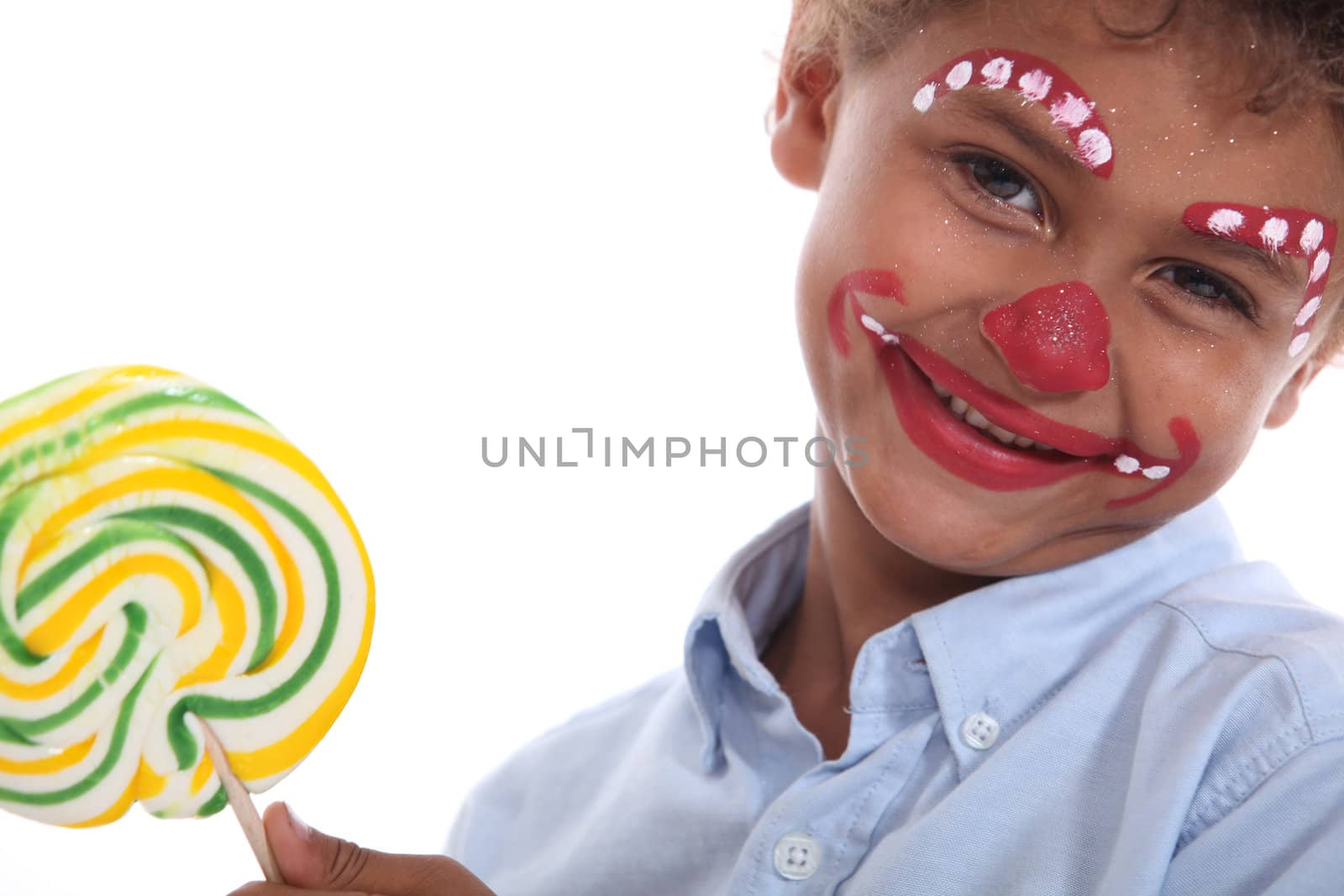 Boy made-up in clown with lollipop by phovoir