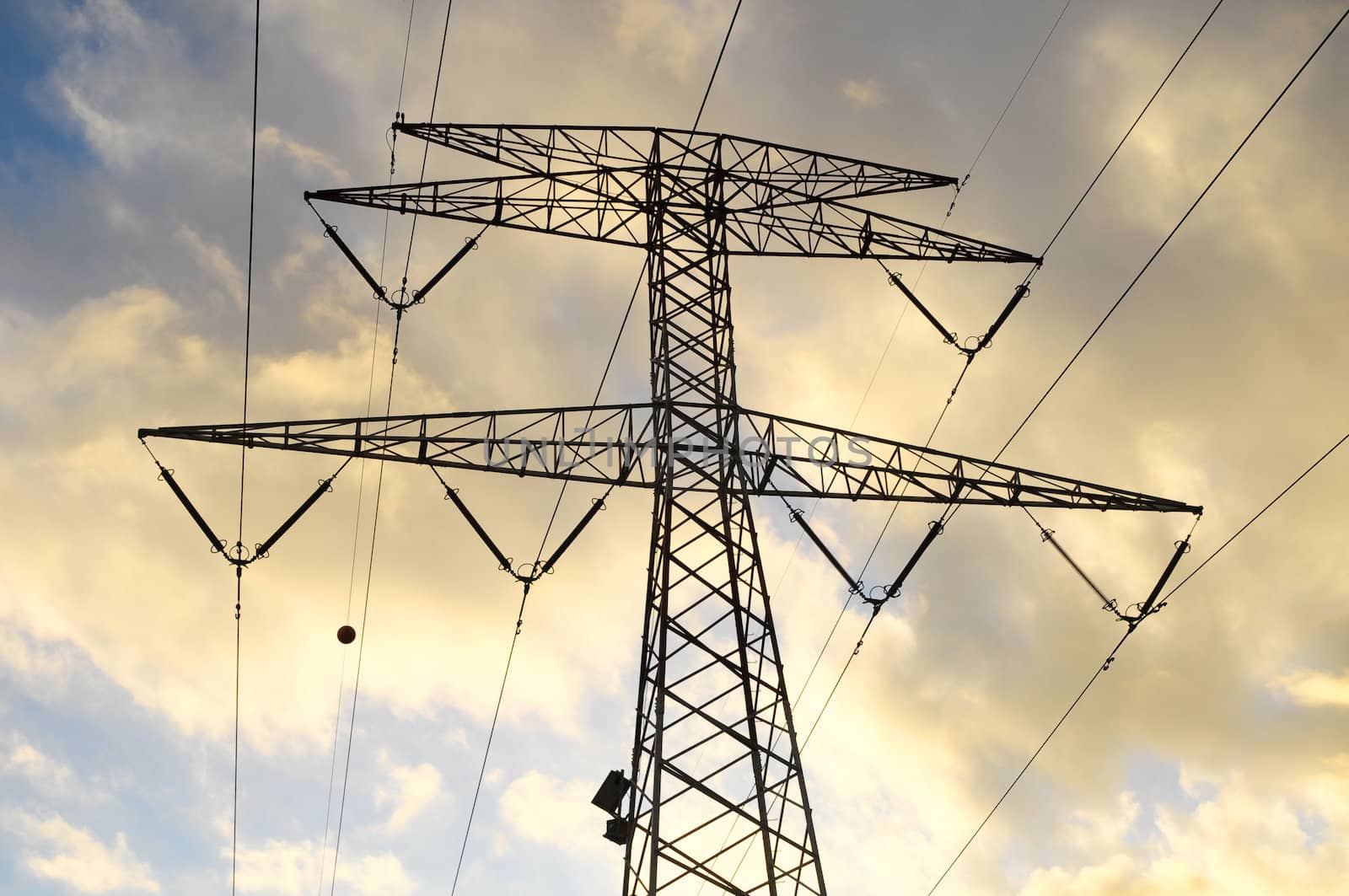 Power Electric Tower on a Cloudy Sky at Sunset