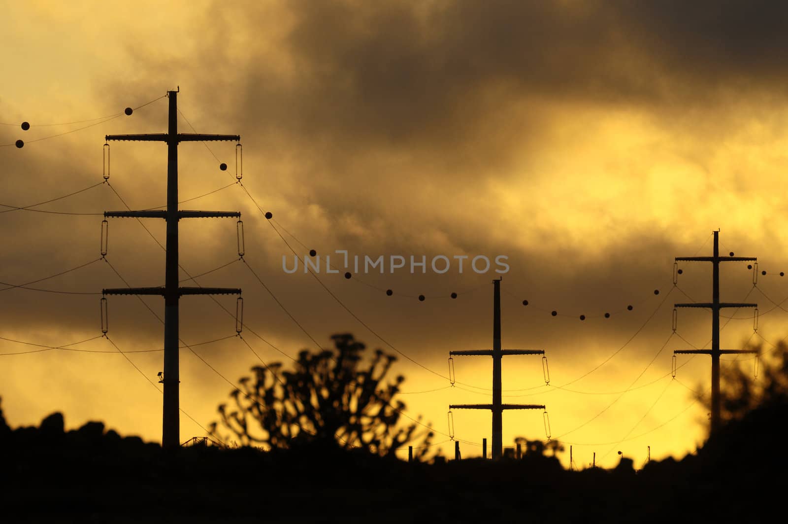 Power Electric Tower on a Cloudy Sky at Sunset