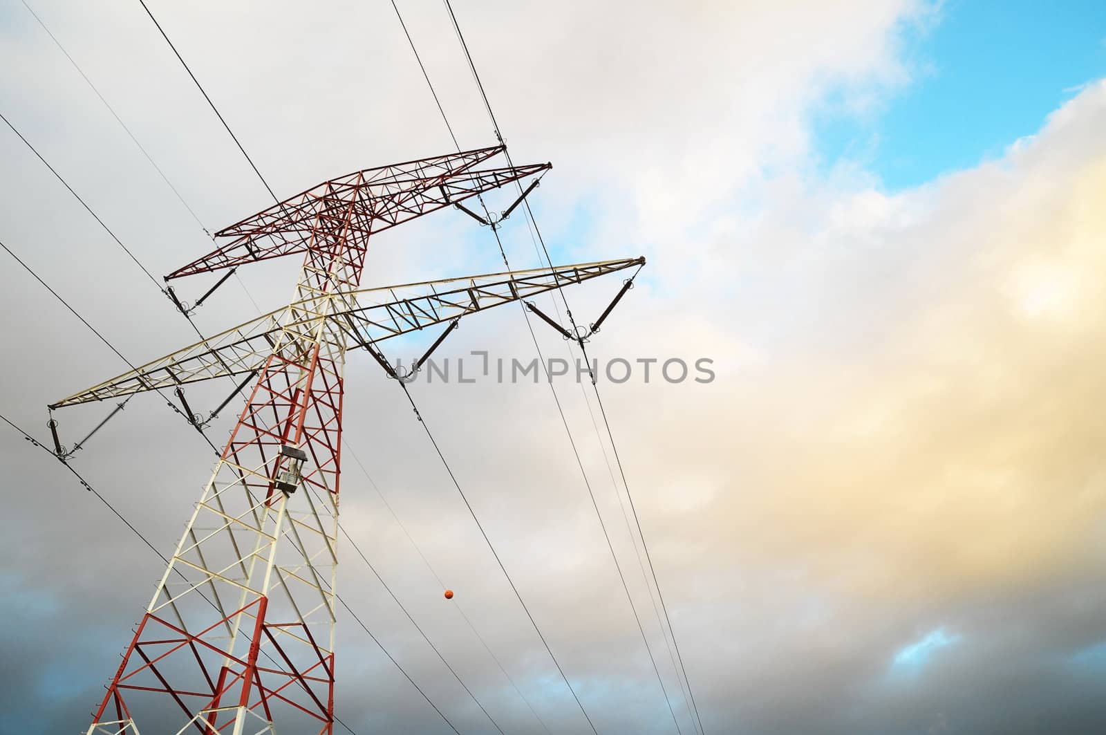 Power Electric Tower on a Cloudy Sky at Sunset