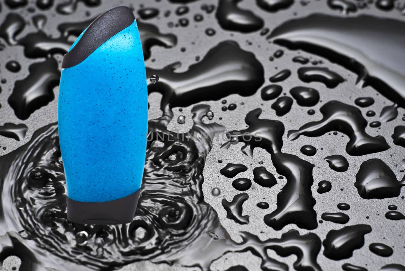Blue shower gel in water stream with splashes
