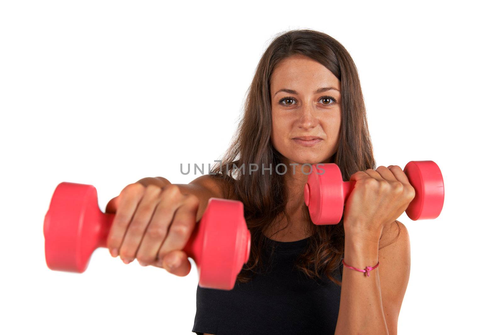 Young woman in the studio with weights working out