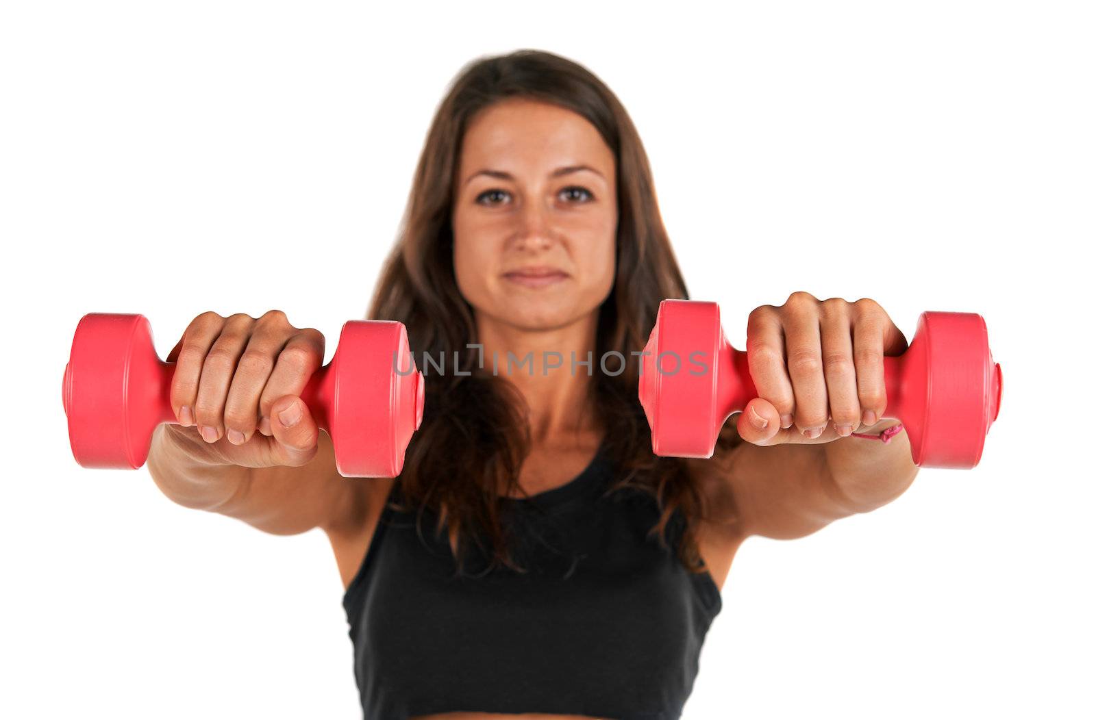 Weights in the hands of a young woman in the studio