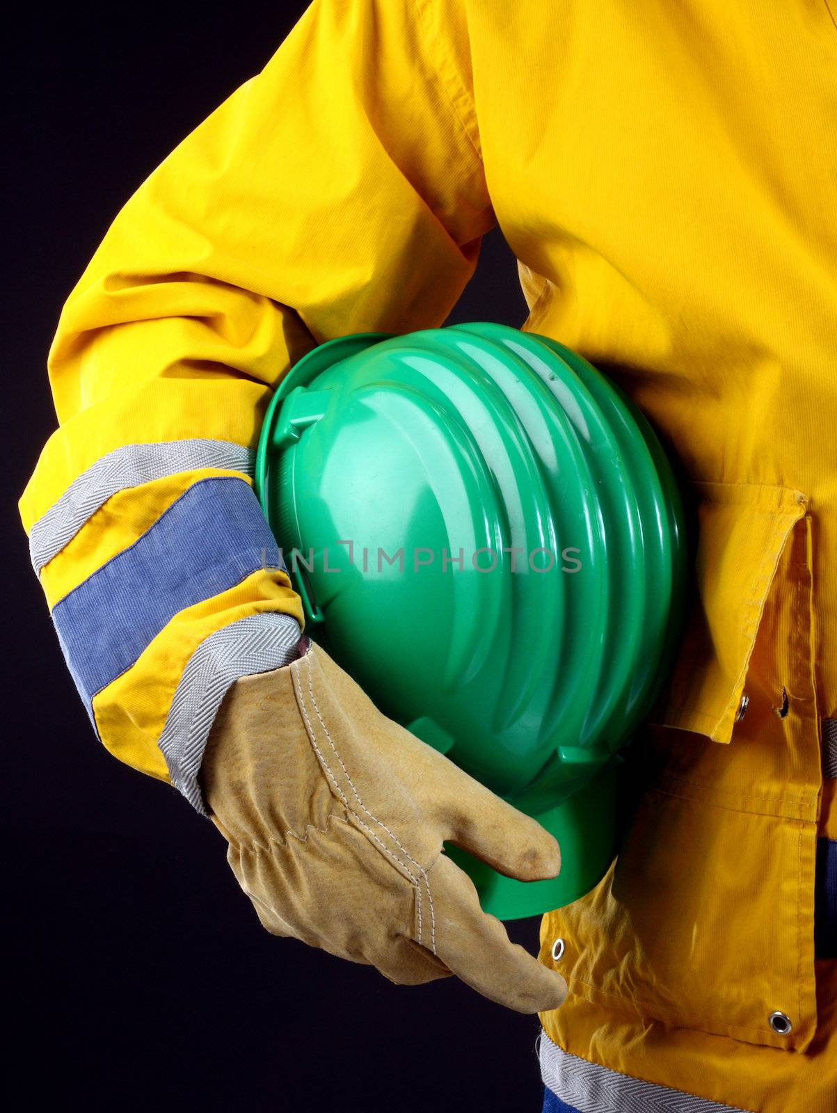 man holding green helmet over black 