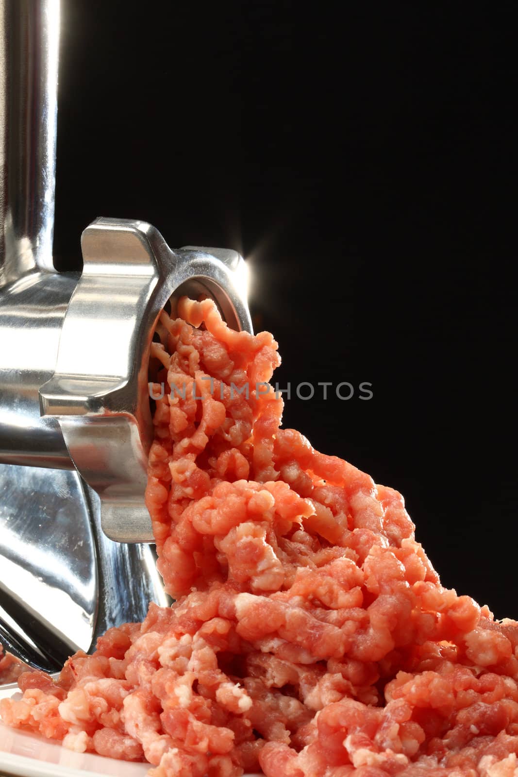 Meat grinder  close up over black  background