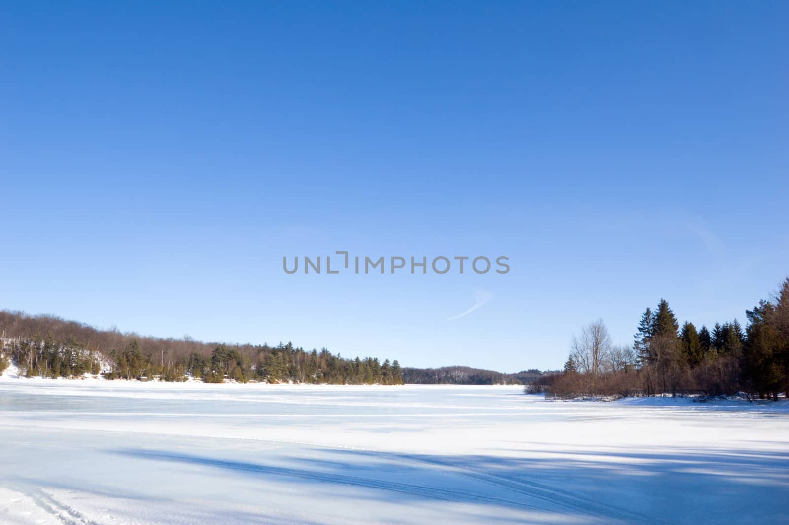 Winter ice lake and stone shore