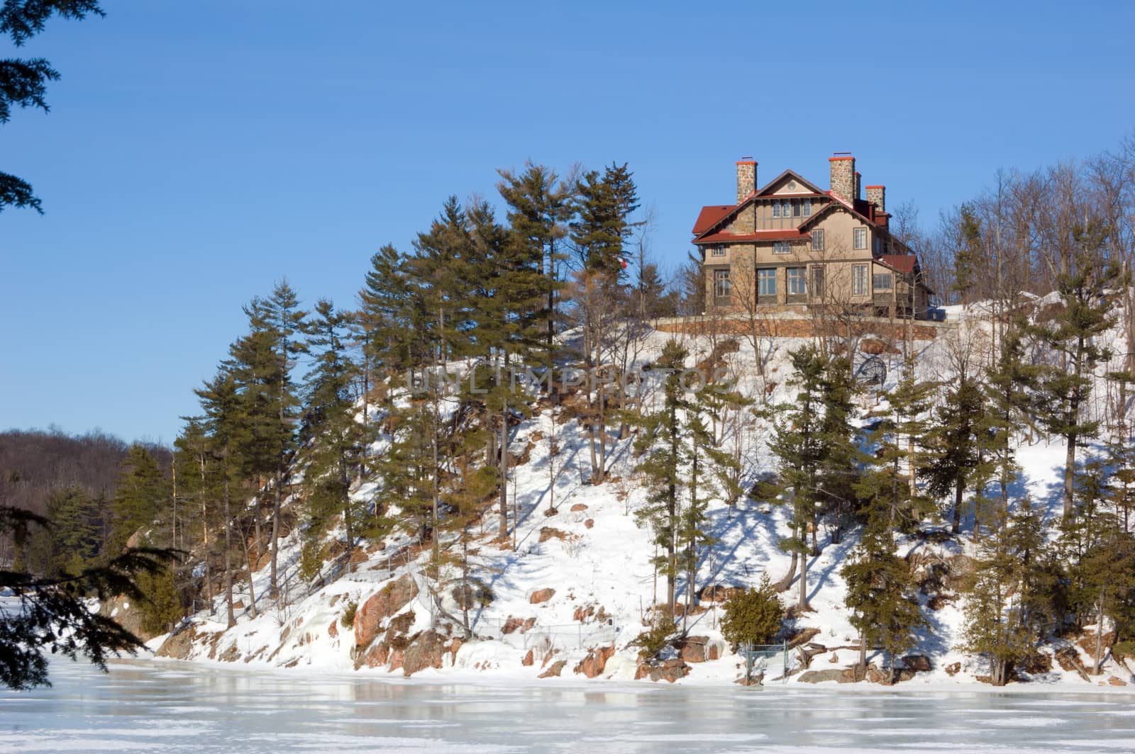 Lone cottage on stone lake shore