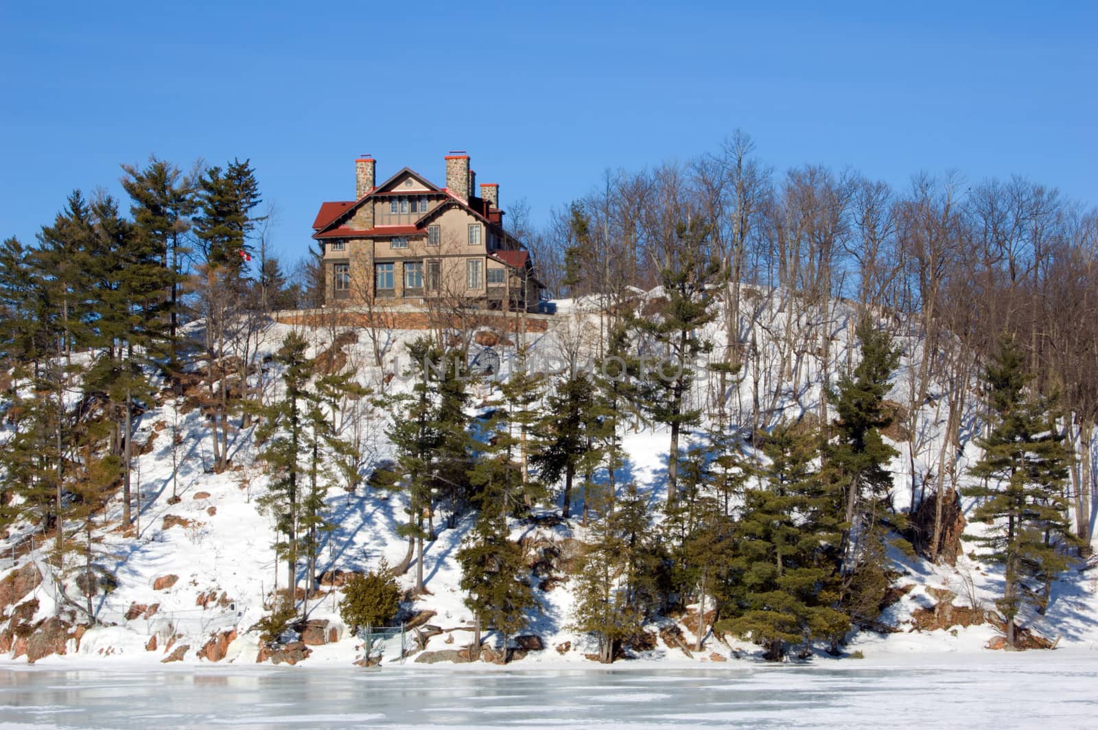 Lone cottage on stone lake shore