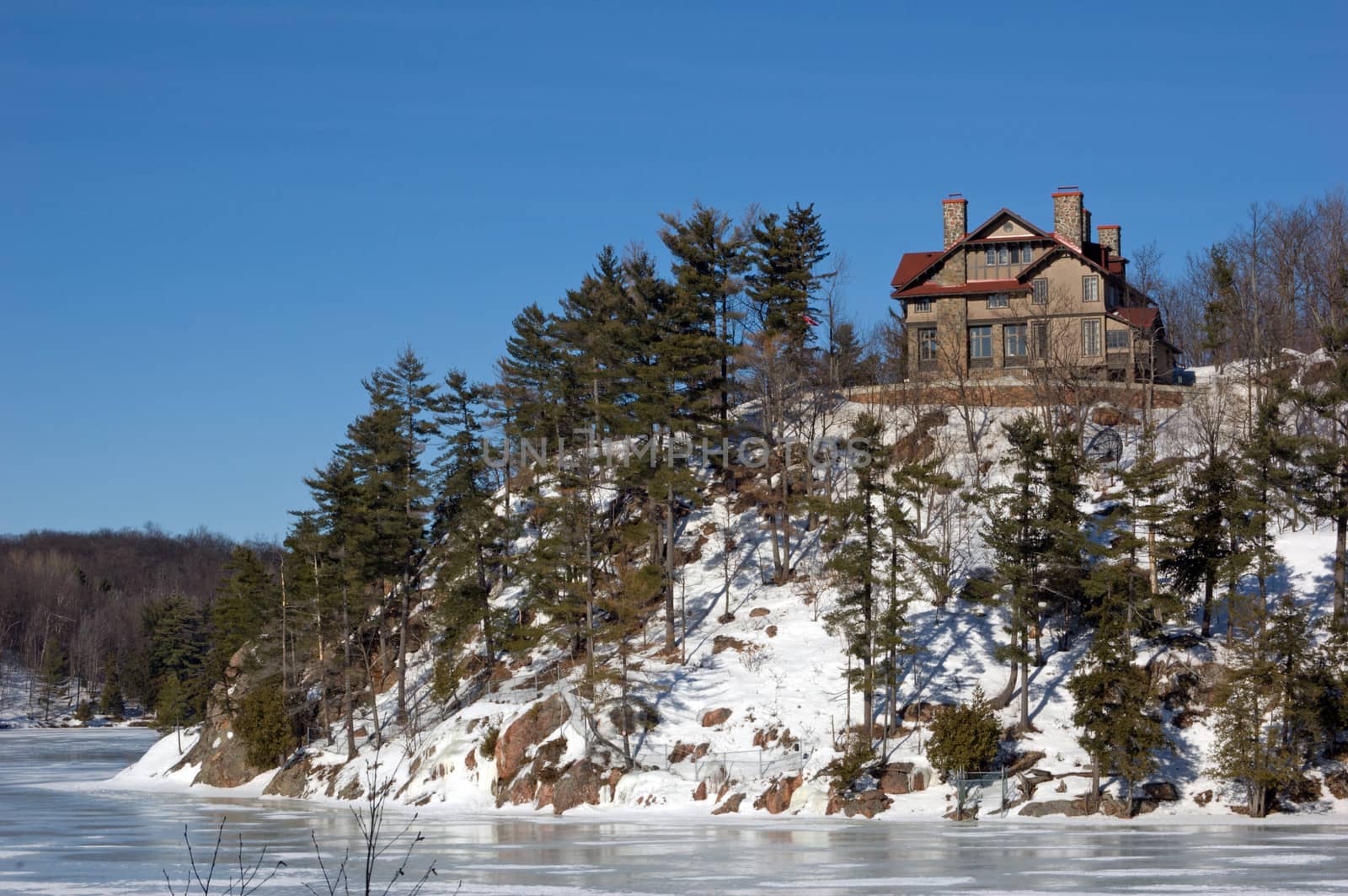 Lone cottage on stone lake shore