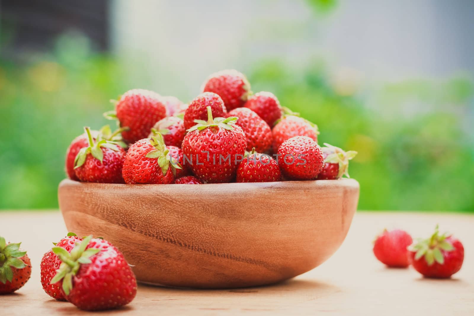 Close-Up Of Strawberries In Vintage Wooden Bowl On Table by ryhor