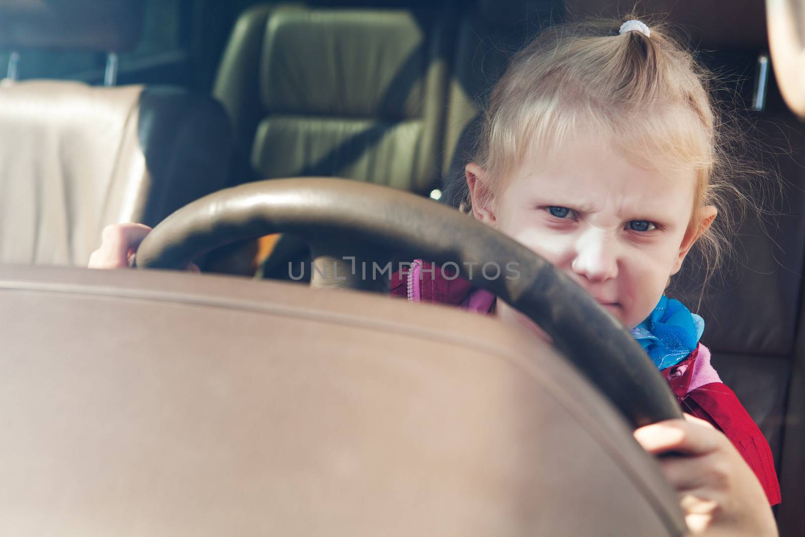 small girl driving a car